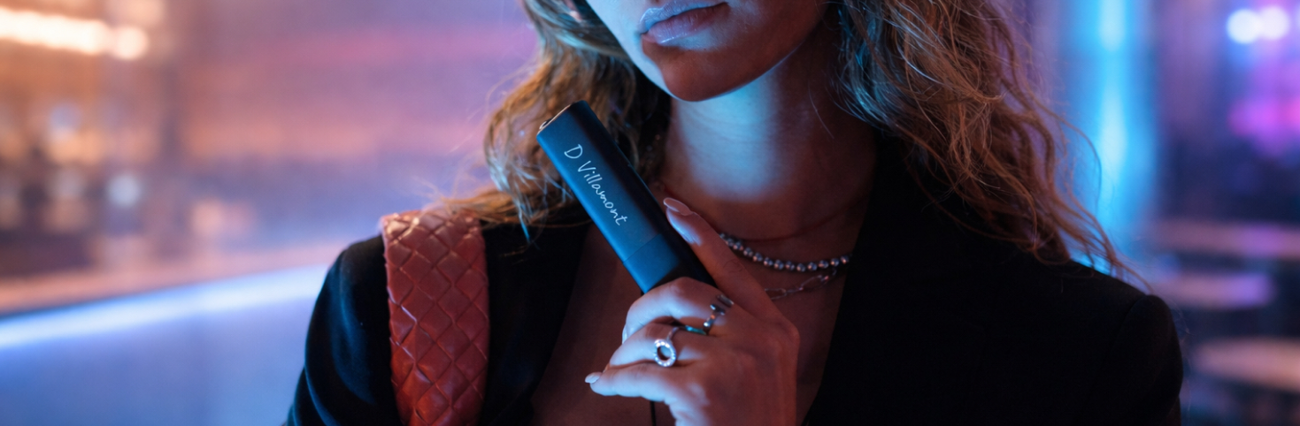 Mujer sosteniendo un dispositivo IQOS Iluma One Black